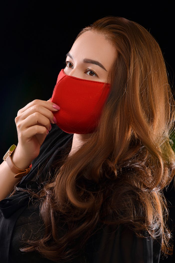 get-in-touch Portrait of a woman wearing a red face mask for health protection and safety.